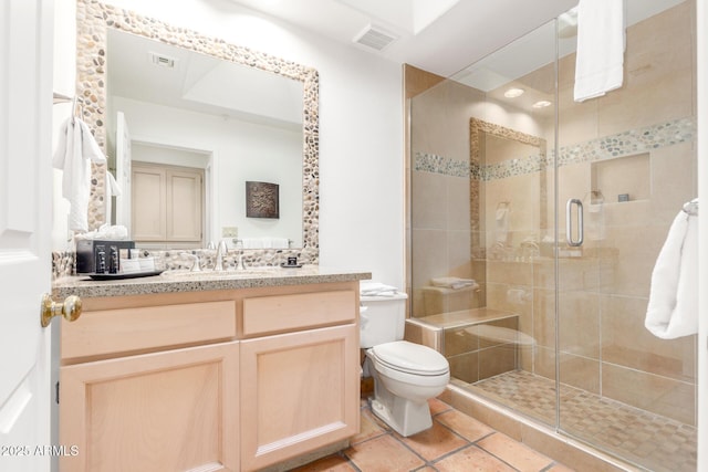 bathroom with vanity, tile patterned flooring, a shower with shower door, and toilet