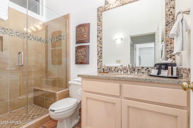 bathroom with walk in shower, vanity, and toilet