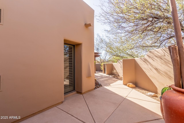 view of side of property with a patio