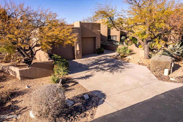 pueblo-style house with a garage