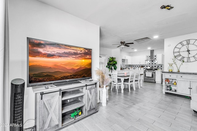 living room featuring ceiling fan and light wood-type flooring