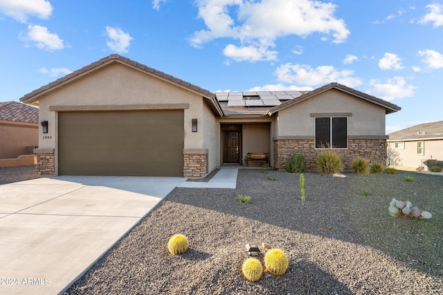 view of front of home featuring a garage and solar panels