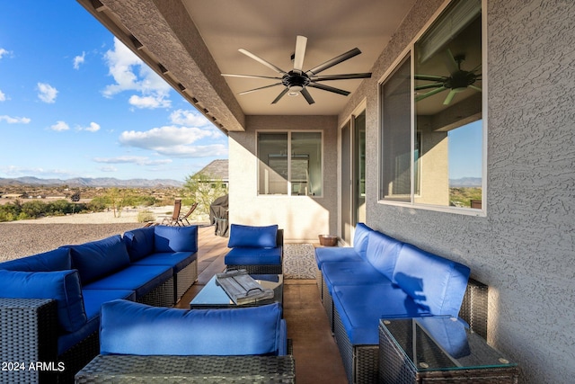 view of patio / terrace with ceiling fan and an outdoor living space