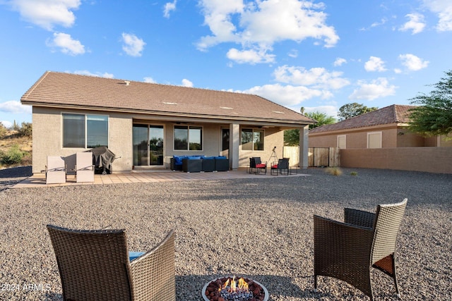 rear view of property featuring outdoor lounge area and a patio