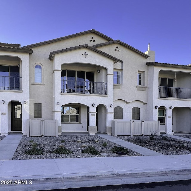 mediterranean / spanish-style home with a balcony