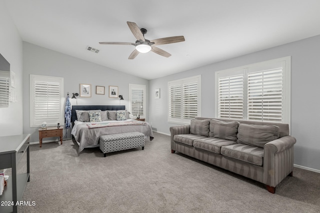 bedroom with lofted ceiling, ceiling fan, and light carpet