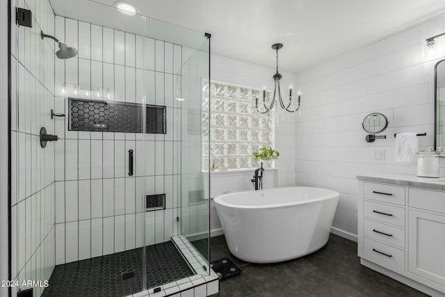 bathroom with separate shower and tub, vanity, an inviting chandelier, and tile walls