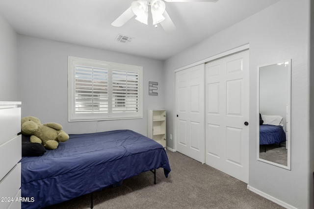 bedroom featuring ceiling fan, a closet, and carpet flooring