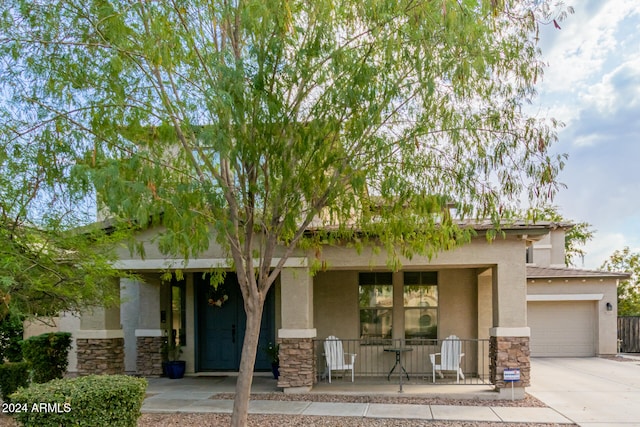 view of front of home featuring a garage and a porch