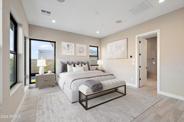 bedroom with light wood finished floors, visible vents, and recessed lighting