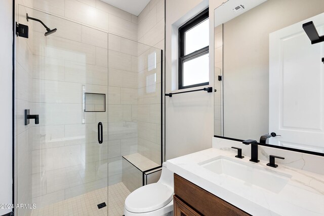 bathroom featuring toilet, a stall shower, visible vents, and vanity