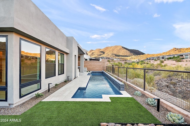 view of pool with a fenced in pool, a lawn, a patio, a fenced backyard, and a mountain view