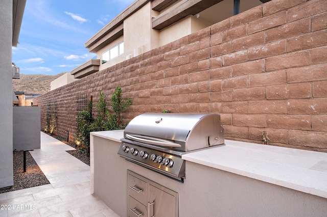 view of patio featuring area for grilling and fence