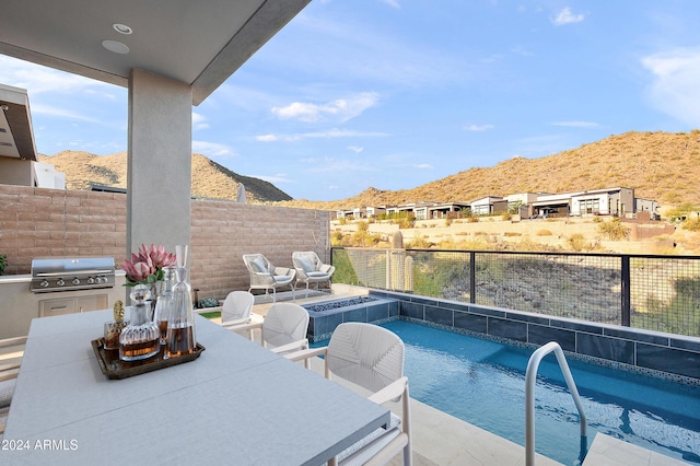 view of swimming pool with a mountain view, fence, a grill, a fenced in pool, and outdoor dining space