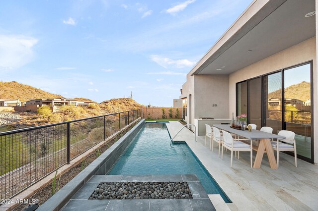 view of pool featuring a fenced in pool, a fenced backyard, and a patio