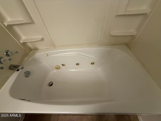 bathroom with a tub with jets