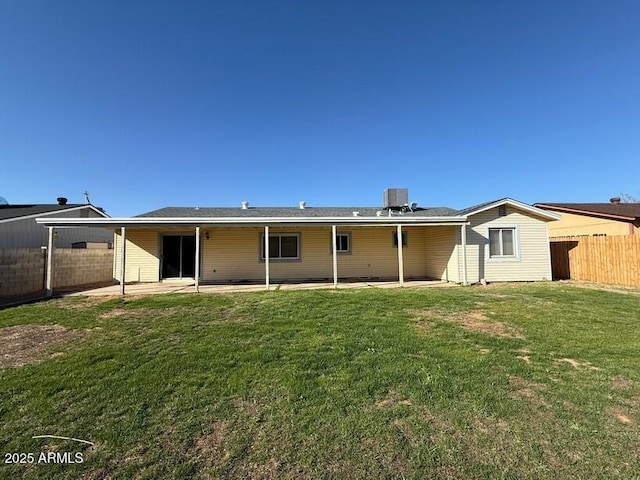 rear view of house with a patio area, central air condition unit, a yard, and fence