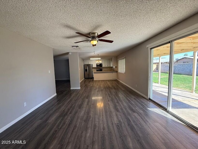 unfurnished living room with a textured ceiling, dark wood-style floors, baseboards, and ceiling fan