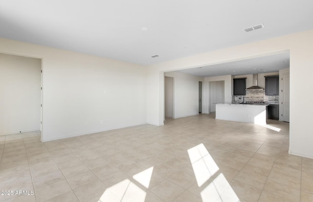 unfurnished living room with visible vents