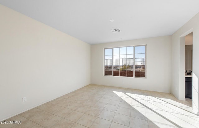 empty room with visible vents and light tile patterned flooring