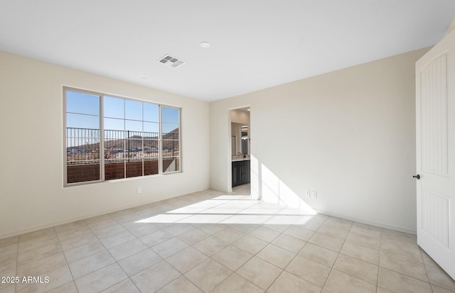 unfurnished bedroom featuring light tile patterned floors and visible vents