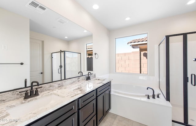 full bathroom featuring a bath, a shower stall, visible vents, and a sink