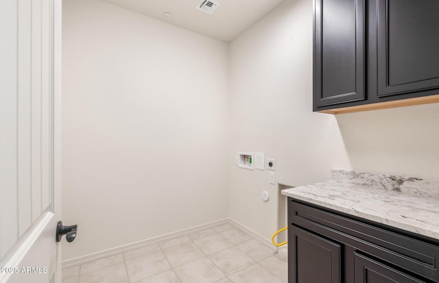 clothes washing area with washer hookup, visible vents, cabinet space, electric dryer hookup, and baseboards