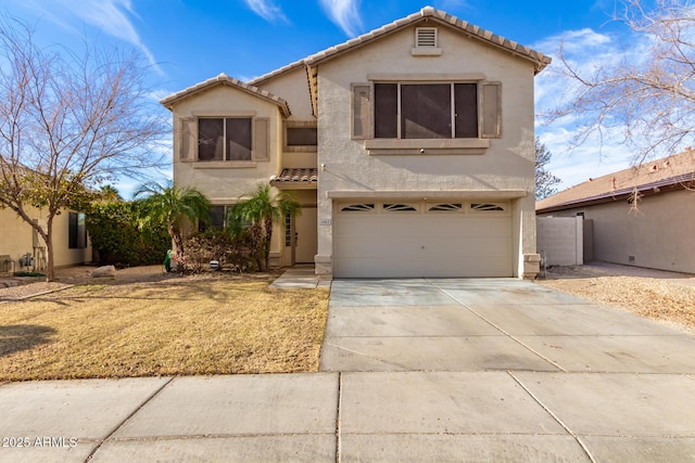 mediterranean / spanish-style home featuring driveway, an attached garage, a tiled roof, and stucco siding