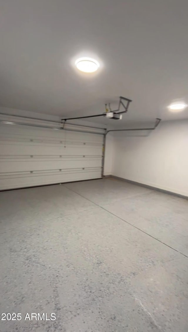garage with baseboards and a garage door opener