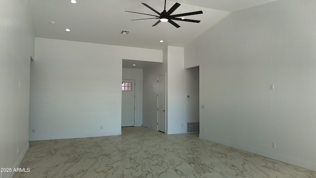 empty room with high vaulted ceiling, recessed lighting, ceiling fan, and marble finish floor