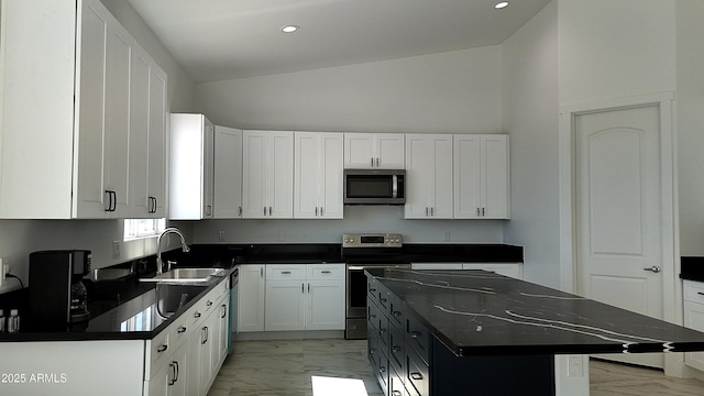 kitchen featuring a sink, appliances with stainless steel finishes, dark countertops, recessed lighting, and marble finish floor