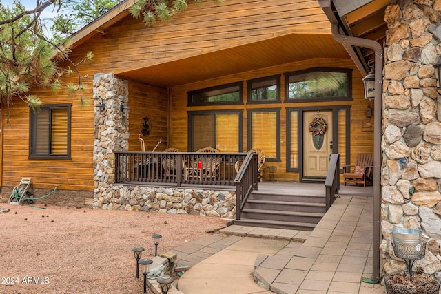 view of exterior entry with covered porch