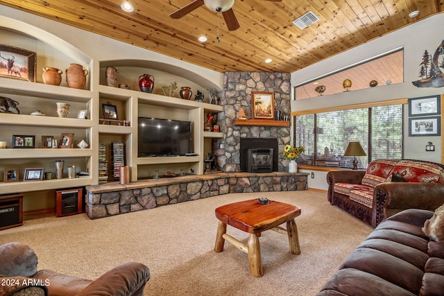 carpeted living room with a fireplace, built in features, ceiling fan, and wood ceiling