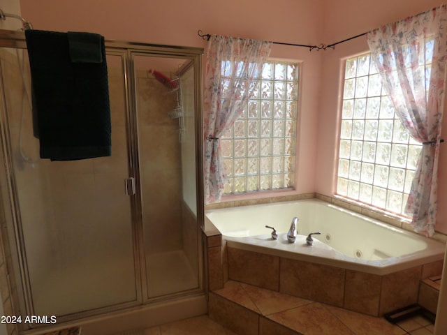 bathroom featuring shower with separate bathtub