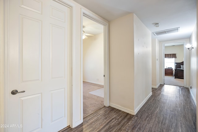 hallway with dark wood-type flooring