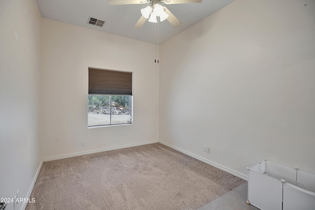 carpeted spare room featuring ceiling fan