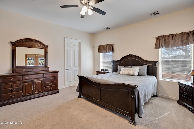 bedroom with ceiling fan and light carpet