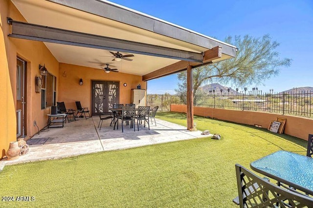 view of yard featuring ceiling fan and a patio area