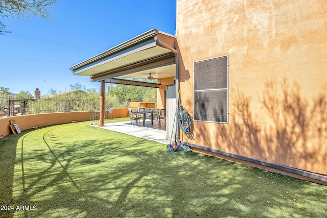 view of yard featuring a patio area and ceiling fan