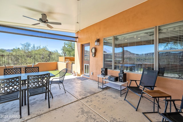 view of patio featuring ceiling fan and a mountain view