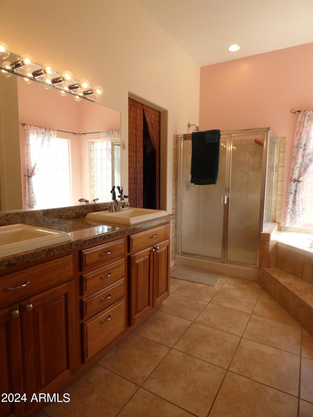 bathroom featuring shower with separate bathtub, vanity, and tile patterned floors