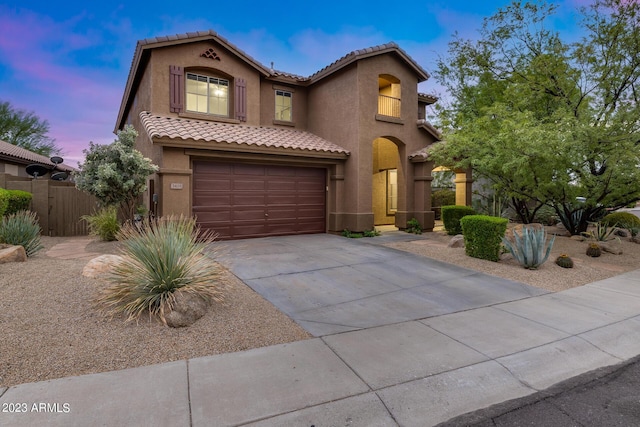 mediterranean / spanish-style home featuring a garage