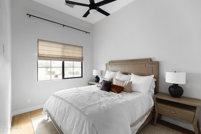 10760 W Golddust Dr, Queen Creek, AZ 85144 - bedroom featuring visible vents, baseboards, ceiling fan, wood finished floors, and lofted ceiling