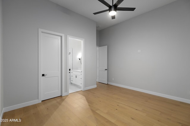10760 W Golddust Dr, Queen Creek, AZ 85144 - unfurnished bedroom with baseboards, ensuite bath, light wood-style floors, and a ceiling fan