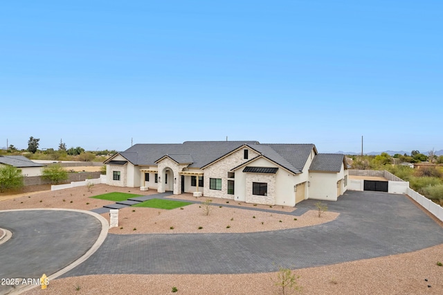 10760 W Golddust Dr, Queen Creek, AZ 85144 - french country home featuring driveway, stone siding, stucco siding, fence, and a tiled roof