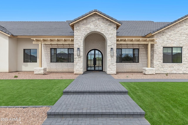 10760 W Golddust Dr, Queen Creek, AZ 85144 - entrance to property with stone siding, french doors, and a lawn