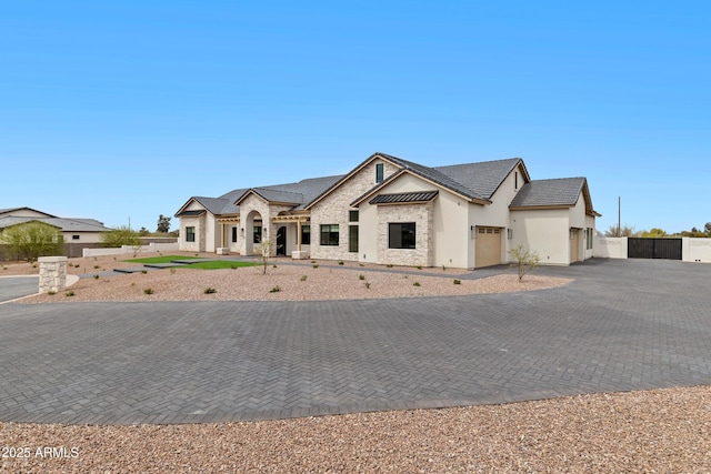 10760 W Golddust Dr, Queen Creek, AZ 85144 - view of front of home featuring fence, roof mounted solar panels, decorative driveway, an attached garage, and stucco siding