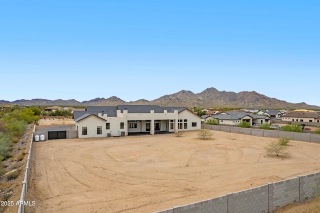 10760 W Golddust Dr, Queen Creek, AZ 85144 - view of front of house with stucco siding, driveway, a mountain view, and fence