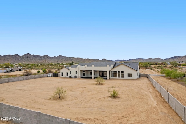 10760 W Golddust Dr, Queen Creek, AZ 85144 - view of front facade featuring driveway, a mountain view, a fenced backyard, and stucco siding