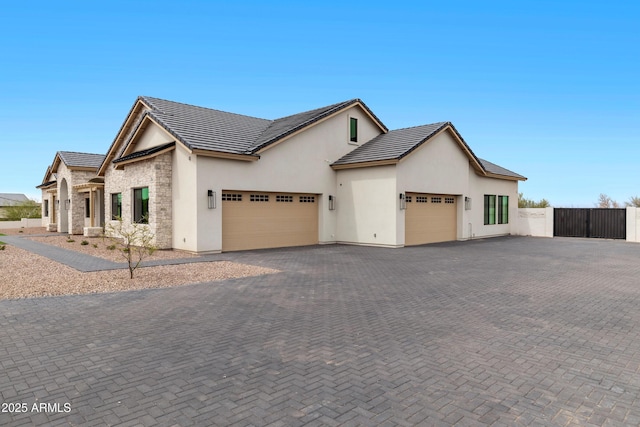 10760 W Golddust Dr, Queen Creek, AZ 85144 - view of front of property with stucco siding, a tiled roof, driveway, a gate, and a garage